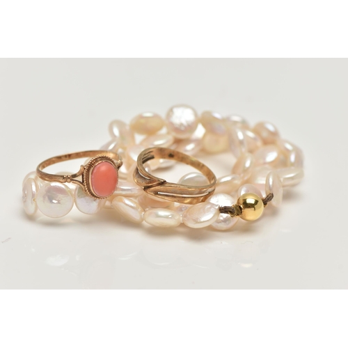 28 - TWO RINGS AND A CULTURED PEARL NECKLACE, the first  a coral cabochon ring, bifurcated shoulders lead... 