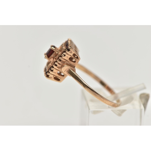 47 - A 9CT GOLD GARNET DRESS RING, rectangular form, set with a principle oval cut garnet and eighteen ci... 