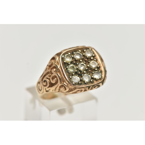 52 - A 9CT GOLD NINE STONE SIGNET RING, square signet set with nine colourless stones assessed as paste, ... 