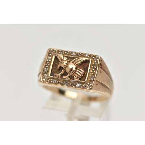 54 - A 9CT GOLD EAGLE SIGNET RING, of a rectangular form depicting a flying eagle, in a surround of singl... 