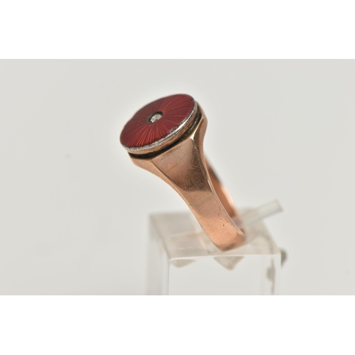 64 - A GENTS 9CT GOLD SIGNET RING, featuring a circular red guilloche enamel ring head set with a single,... 