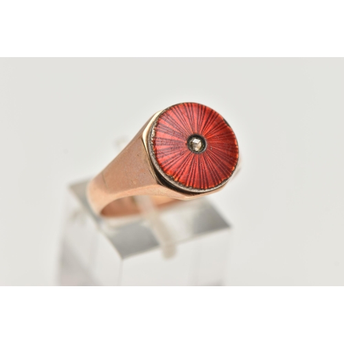 64 - A GENTS 9CT GOLD SIGNET RING, featuring a circular red guilloche enamel ring head set with a single,... 