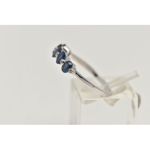 11 - A WHITE METAL SAPPHIRE AND DIAMOND HALF ETERNITY RING, designed with a row of five oval cut blue sap... 