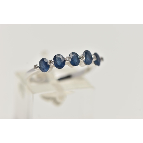 11 - A WHITE METAL SAPPHIRE AND DIAMOND HALF ETERNITY RING, designed with a row of five oval cut blue sap... 