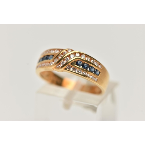 149 - AN 18CT GOLD SAPPHIRE AND DIAMOND HALF ETERNITY RING, designed with a central row of small circular ... 