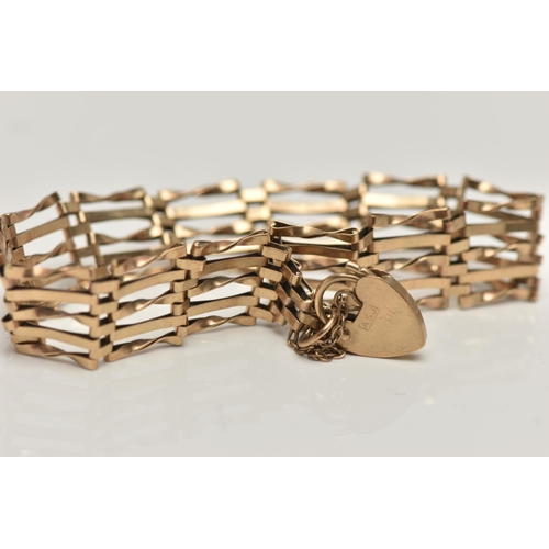 158 - A 9CT GOLD GATE BRACELET, a yellow gold five bar gate bracelet fitted with a heart padlock clasp and... 