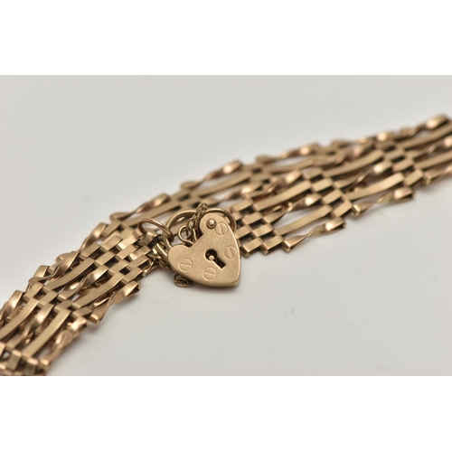 158 - A 9CT GOLD GATE BRACELET, a yellow gold five bar gate bracelet fitted with a heart padlock clasp and... 