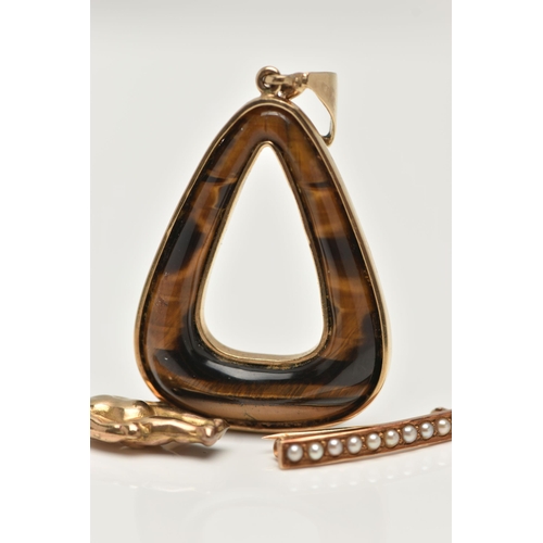 16 - A PENDANT, BROOCH AND A CHARM, the pendant of an open work triangular form, set with tigers eye, fit... 