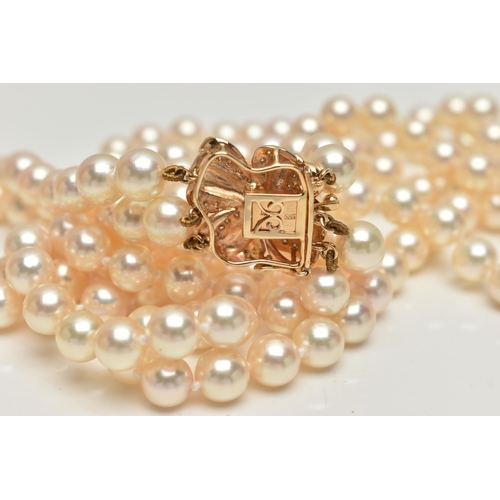 2 - A CULTURED PEARL NECKLACE, designed with three strands of individually knotted cream pearls with a p... 