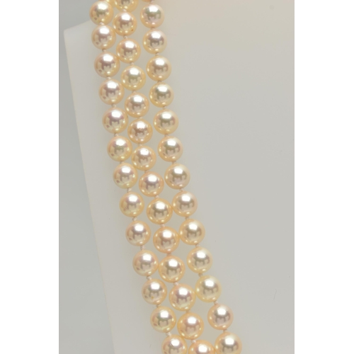 2 - A CULTURED PEARL NECKLACE, designed with three strands of individually knotted cream pearls with a p... 