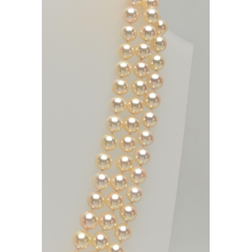 2 - A CULTURED PEARL NECKLACE, designed with three strands of individually knotted cream pearls with a p... 