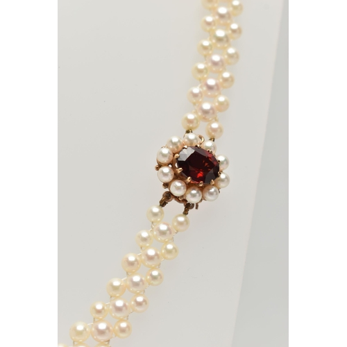 26 - A CULTURED PEARL CHOKER AND BRACELET, designed as a row of three cultured cream pearls with a pink h... 