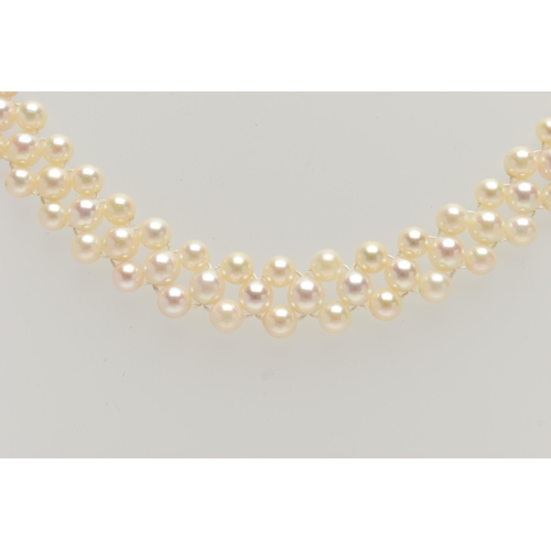 26 - A CULTURED PEARL CHOKER AND BRACELET, designed as a row of three cultured cream pearls with a pink h... 