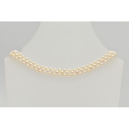 26 - A CULTURED PEARL CHOKER AND BRACELET, designed as a row of three cultured cream pearls with a pink h... 