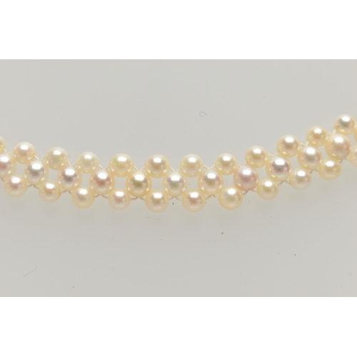 26 - A CULTURED PEARL CHOKER AND BRACELET, designed as a row of three cultured cream pearls with a pink h... 