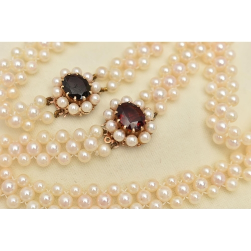 26 - A CULTURED PEARL CHOKER AND BRACELET, designed as a row of three cultured cream pearls with a pink h... 