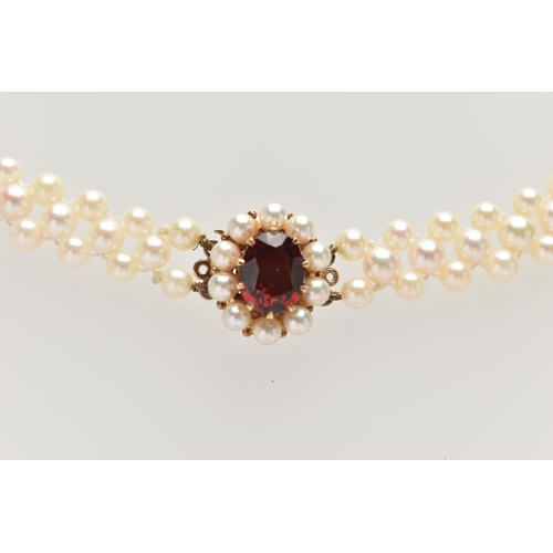 26 - A CULTURED PEARL CHOKER AND BRACELET, designed as a row of three cultured cream pearls with a pink h... 