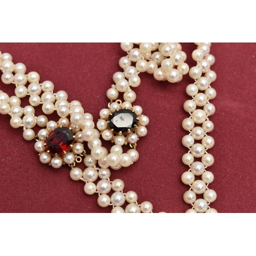 26 - A CULTURED PEARL CHOKER AND BRACELET, designed as a row of three cultured cream pearls with a pink h... 