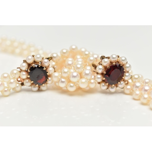 26 - A CULTURED PEARL CHOKER AND BRACELET, designed as a row of three cultured cream pearls with a pink h... 