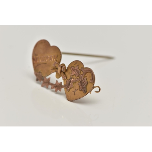 36 - A YELLOW METAL SWEETHEART BROOCH, designed as two hearts with a bow and ivy leaf detail, inscribed '... 