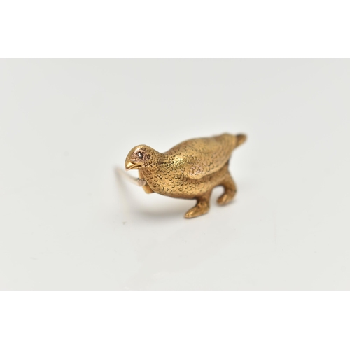 103 - A YELLOW METAL BROOCH, in the form of a textured game bird, set with a small diamond chip eye, stamp... 