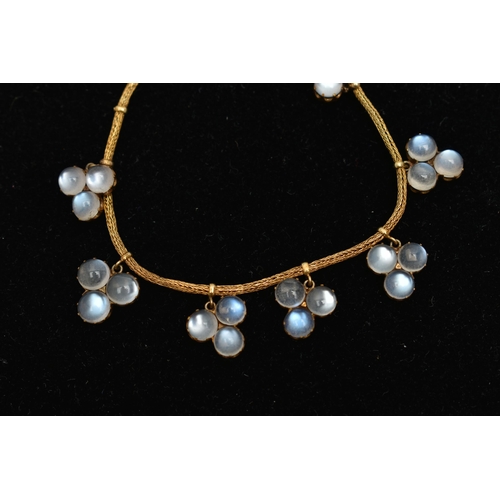 110 - A LATE VICTORIAN YELLOW METAL MOONSTONE PENDANT NEACKLACE, designed with a series of fifteen trefoil... 