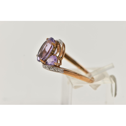 123 - AN AMETHYST AND DIAMOND RING, designed as an oval amethyst flanked by pear shape amethysts to the cr... 