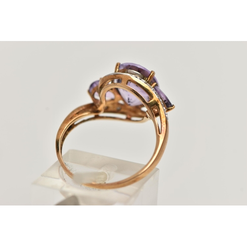 123 - AN AMETHYST AND DIAMOND RING, designed as an oval amethyst flanked by pear shape amethysts to the cr... 