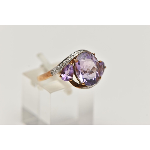 123 - AN AMETHYST AND DIAMOND RING, designed as an oval amethyst flanked by pear shape amethysts to the cr... 