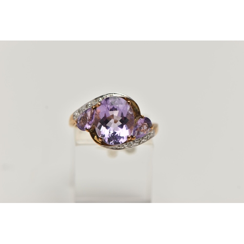 123 - AN AMETHYST AND DIAMOND RING, designed as an oval amethyst flanked by pear shape amethysts to the cr... 