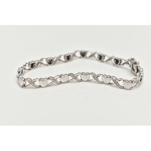 127 - A 9CT WHITE GOLD BRACELET, designed as a series of polished hearts and single cut diamond set cross ... 