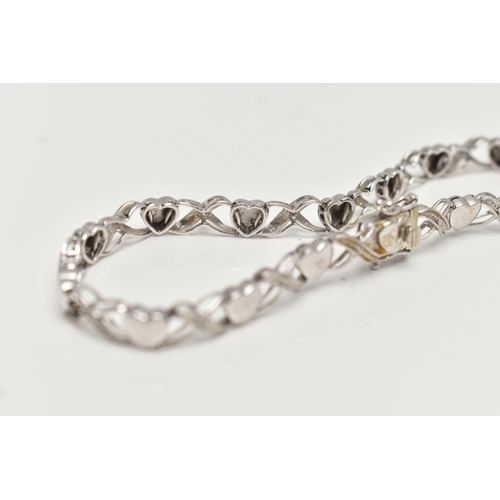 127 - A 9CT WHITE GOLD BRACELET, designed as a series of polished hearts and single cut diamond set cross ... 