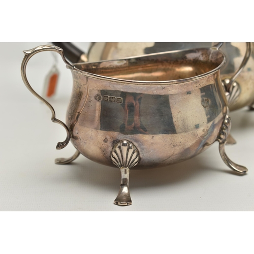 214 - AN EARLY 20TH CENTURY THREE PIECE SILVER TEA SERVICE SET, comprising of a polished teapot, raised on... 