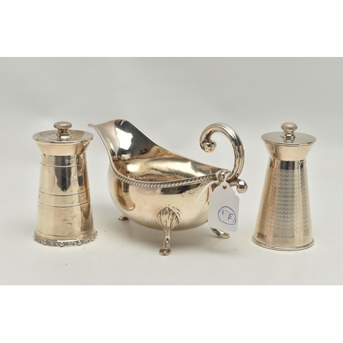 219 - AN ELIZABETH II SILVER SAUCE BOAT AND TWO ELIZABETH II SILVER MILK CHURN SHAPED PEPPERMILLS, the sau... 