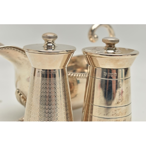 219 - AN ELIZABETH II SILVER SAUCE BOAT AND TWO ELIZABETH II SILVER MILK CHURN SHAPED PEPPERMILLS, the sau... 