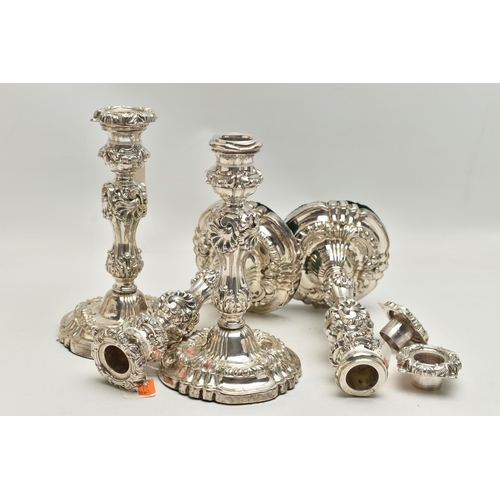 226 - A SET OF FOUR GEORGE IV SILVER CANDLESTICKS, circular form with foliage and scrolling detail to the ... 