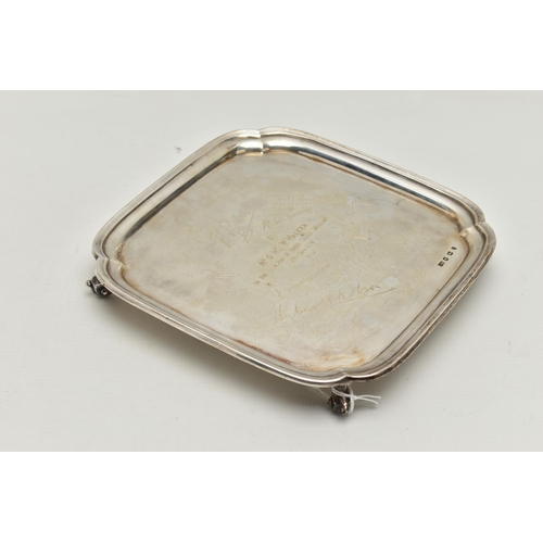 232 - AN EARLY 20TH CENTURY SILVER WAITER, of a polished square form, personal engraving to the centre rea... 