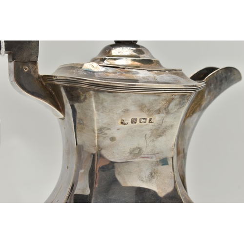 233 - A GEORGE V SILVER COFFEE POT, polished faceted form, fitted with an ebonised handle and finial, rais... 