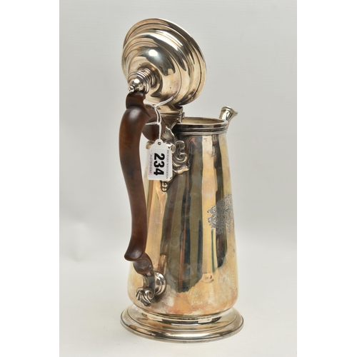 234 - A GEORGIAN SILVER COFFEE POT, tall polished pot with engraved family crest, leaf detail to the spout... 