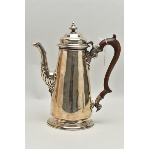 234 - A GEORGIAN SILVER COFFEE POT, tall polished pot with engraved family crest, leaf detail to the spout... 