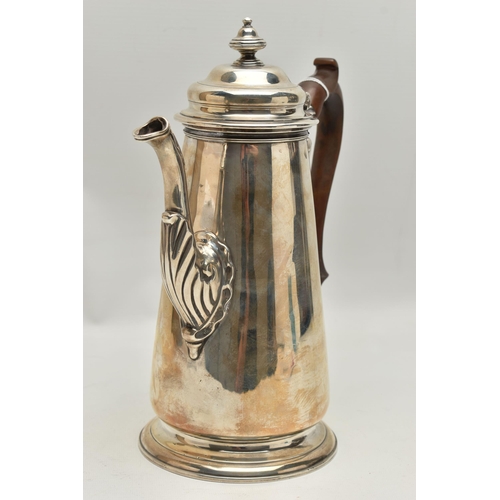 234 - A GEORGIAN SILVER COFFEE POT, tall polished pot with engraved family crest, leaf detail to the spout... 