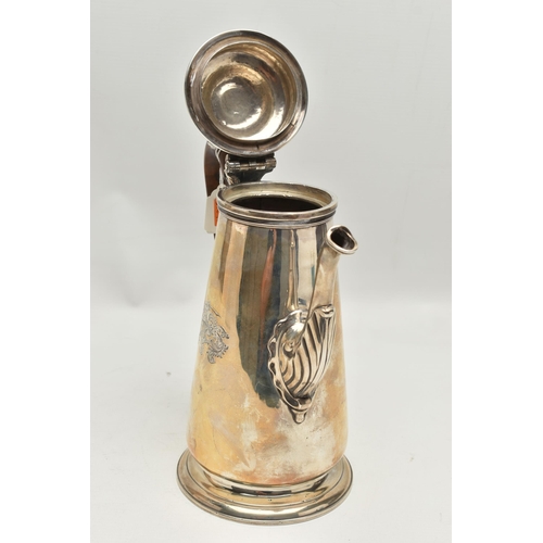 234 - A GEORGIAN SILVER COFFEE POT, tall polished pot with engraved family crest, leaf detail to the spout... 