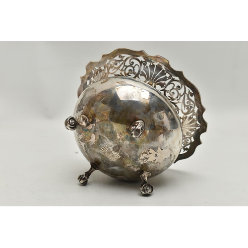 236 - A SILVER BONBON DISH, deep round bowl with a worn gilt interior, wavy open work rim, raised on four ... 