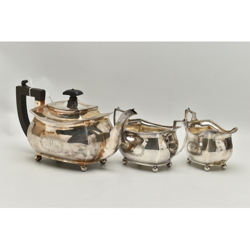 237 - A GEORGE V THREE PIECE SILVER TEA SET, comprising of a polished teapot with engraved initial 'R' in ... 