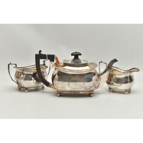 237 - A GEORGE V THREE PIECE SILVER TEA SET, comprising of a polished teapot with engraved initial 'R' in ... 