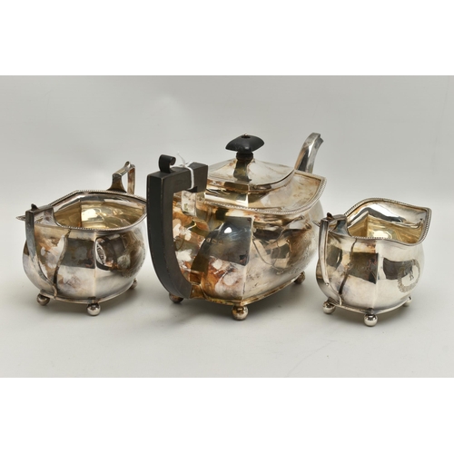 237 - A GEORGE V THREE PIECE SILVER TEA SET, comprising of a polished teapot with engraved initial 'R' in ... 