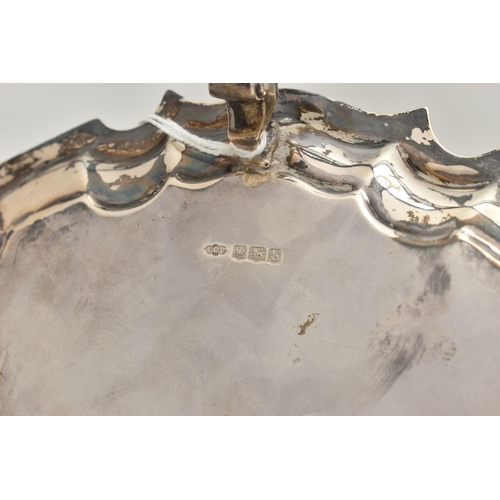 241 - A GEORGE V SILVER WAITER, circular form with wavy rim, raised on three scroll feet, personal engravi... 