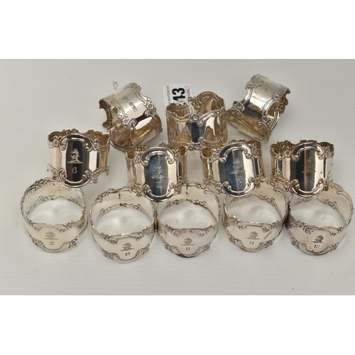 243 - A SET OF TWELVE EARLY 20TH CENTURY, SILVER NAPKIN RINGS, each ring with engraved family crest with A... 