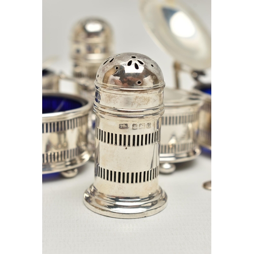 244 - AN EIGHT PIECE SILVER CONDIMENT SET, comprising of four pierced salts each on four ball feet with bl... 