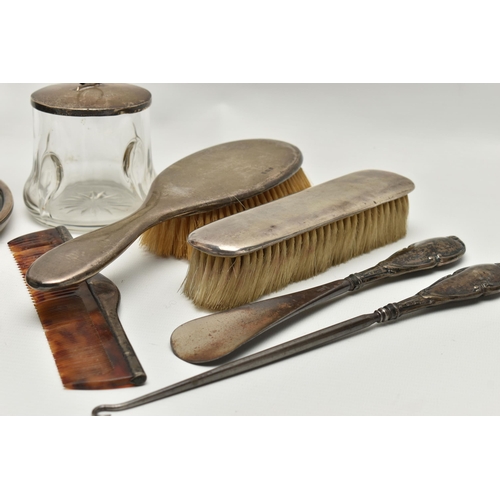 249 - A SELECTION OF SILVER VANITY ITEMS, to include a four piece, polished silver dressing table set, com... 